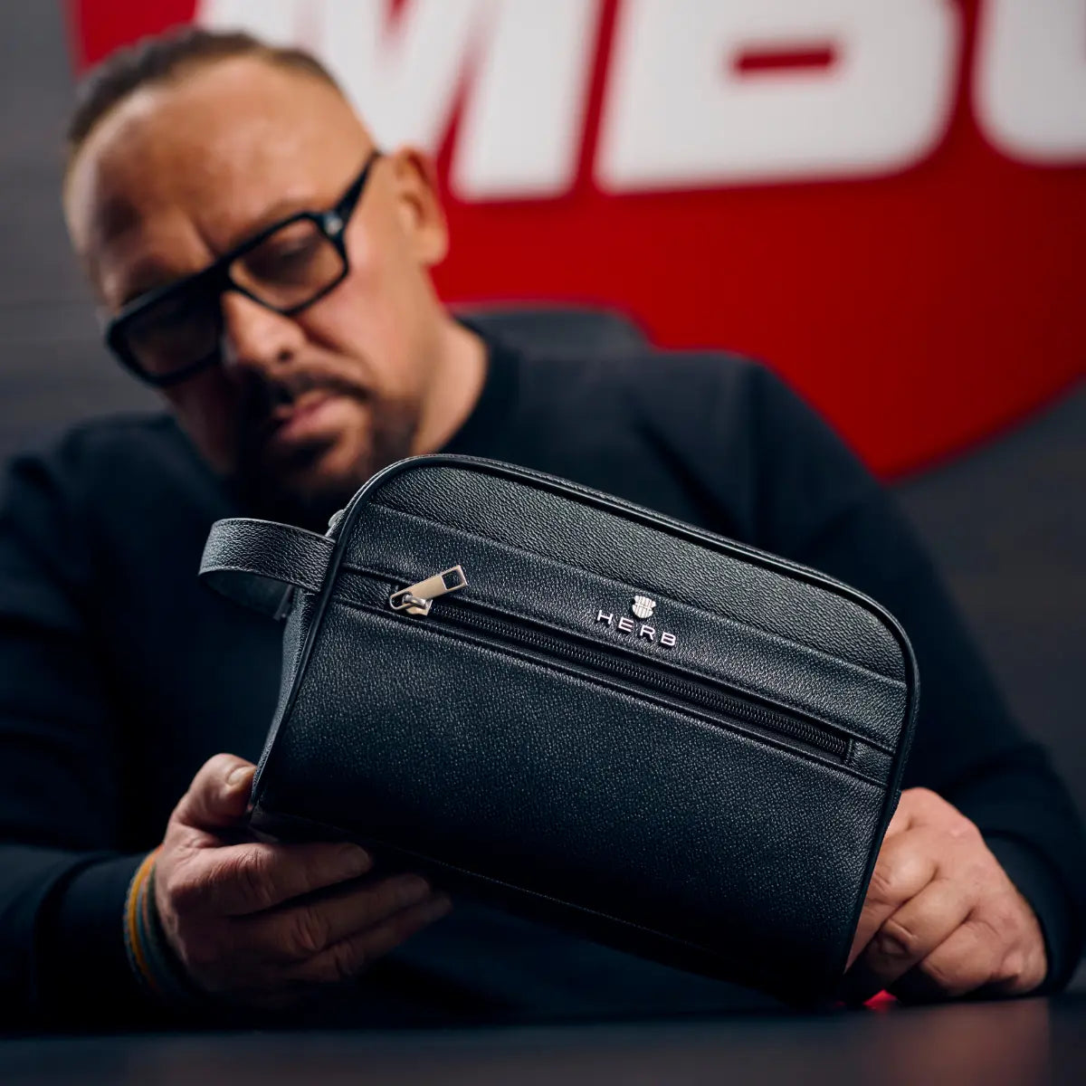 Andreas Herb mit washbag am Schreibtisch